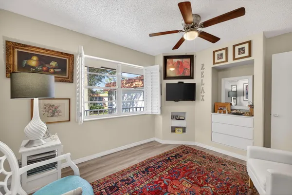 a living room with furniture and painting on the wall