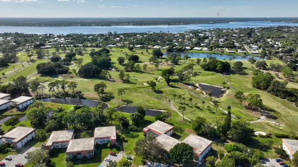 a dining room with furniture and a floor to ceiling window