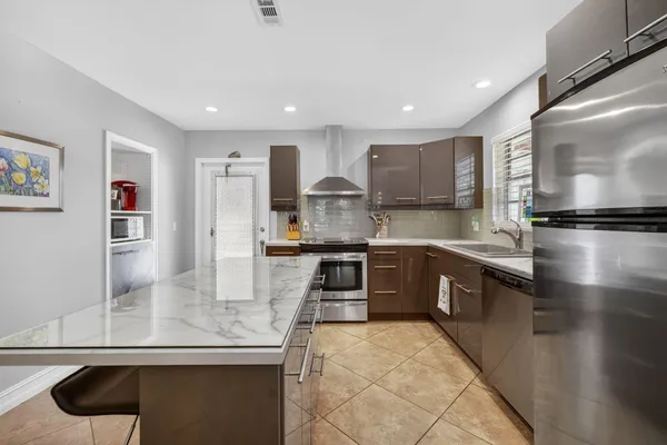 a kitchen with a stove and a refrigerator