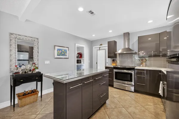 a dining room with furniture a chandelier and window
