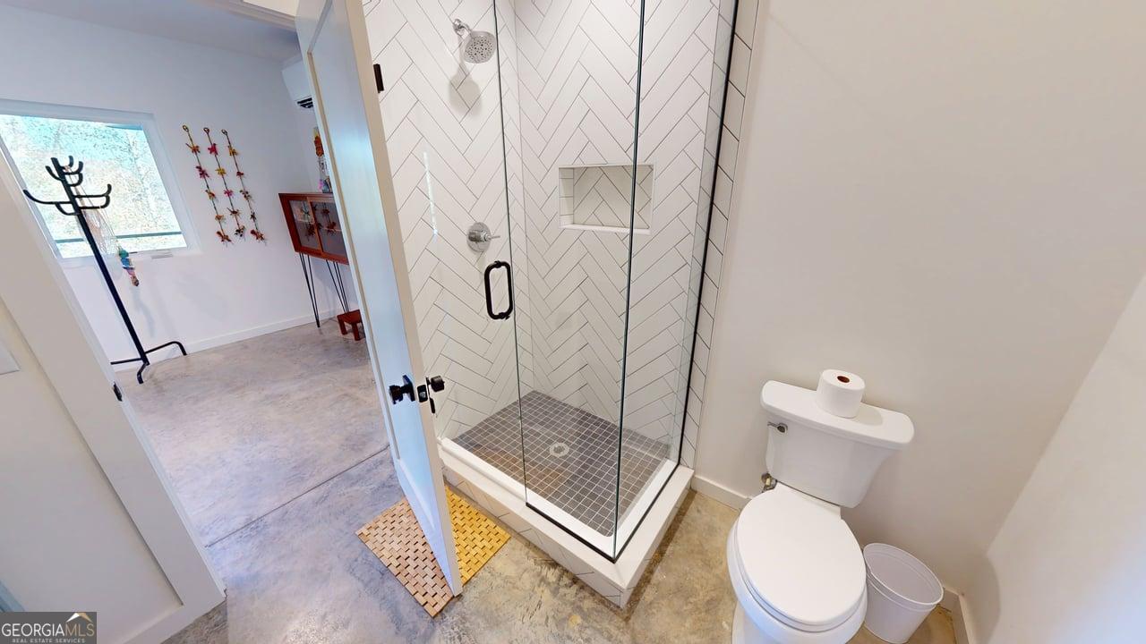 458 Brannon Ridge Young Harris, GA 30582 - Photo 17 of 34 a white toilet sitting next to a bathroom sink