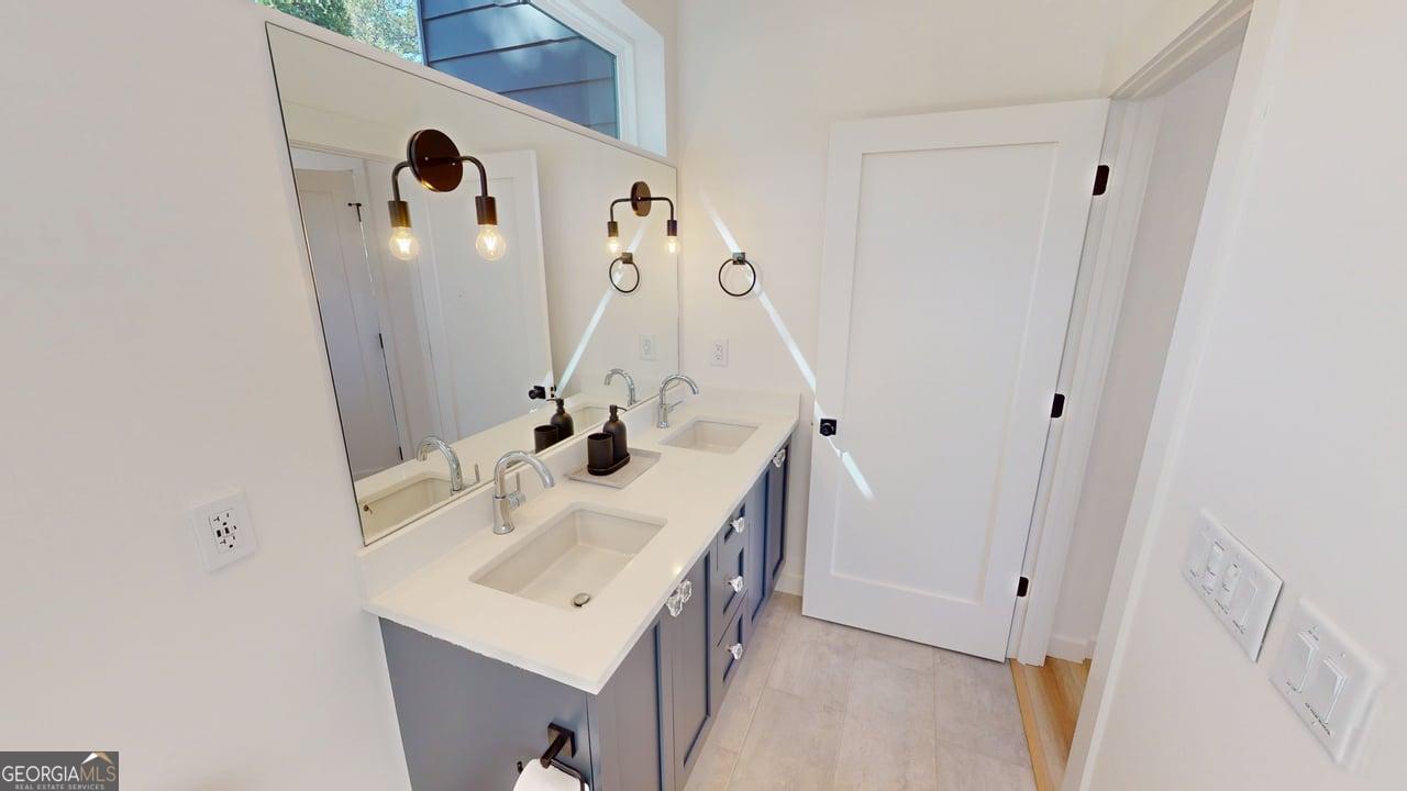 458 Brannon Ridge Young Harris, GA 30582 - Photo 20 of 34 a bathroom with a sink a mirror and vanity