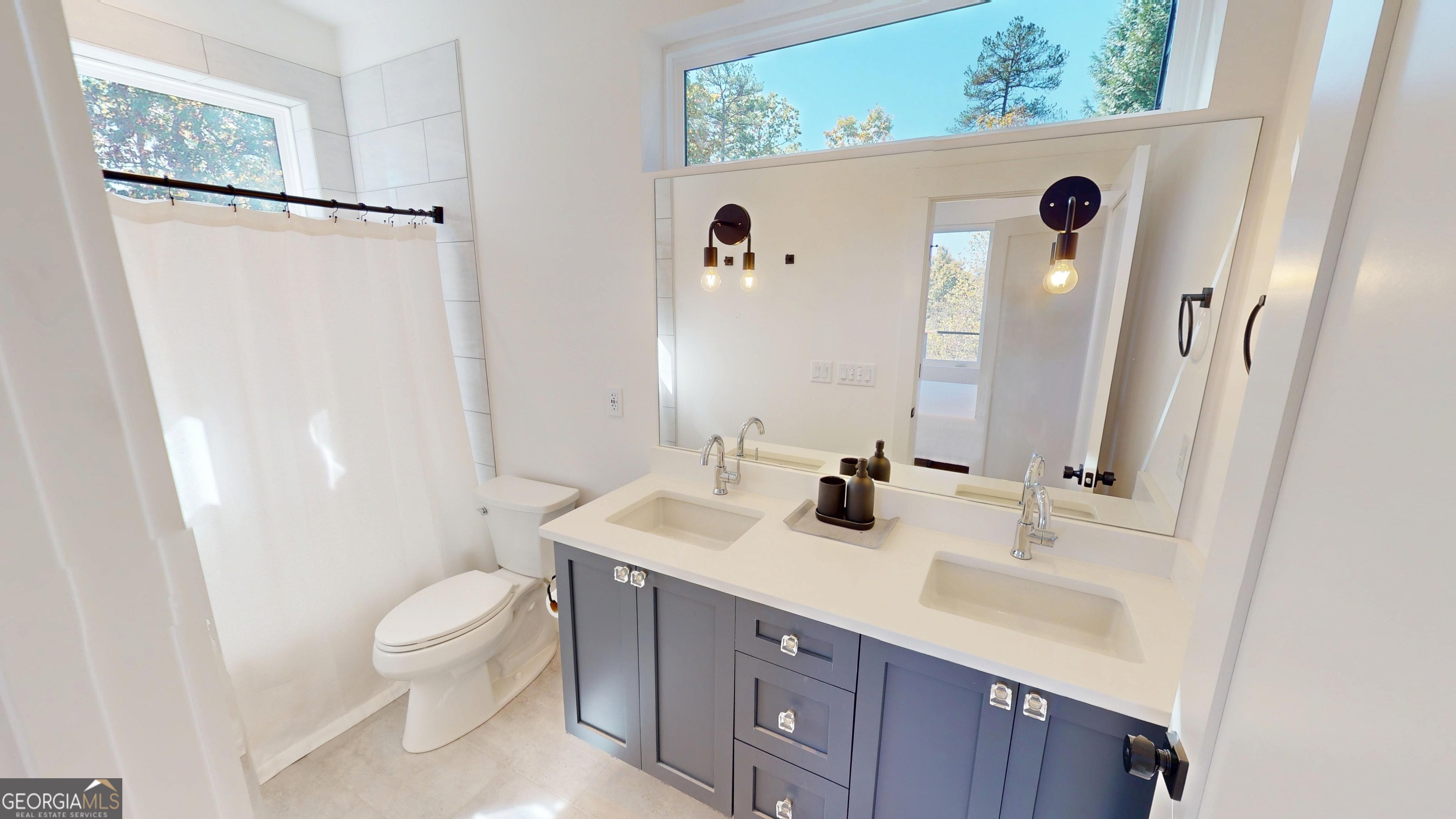 458 Brannon Ridge Young Harris, GA 30582 - Photo 24 of 34 a bathroom with a sink a toilet a mirror and shower