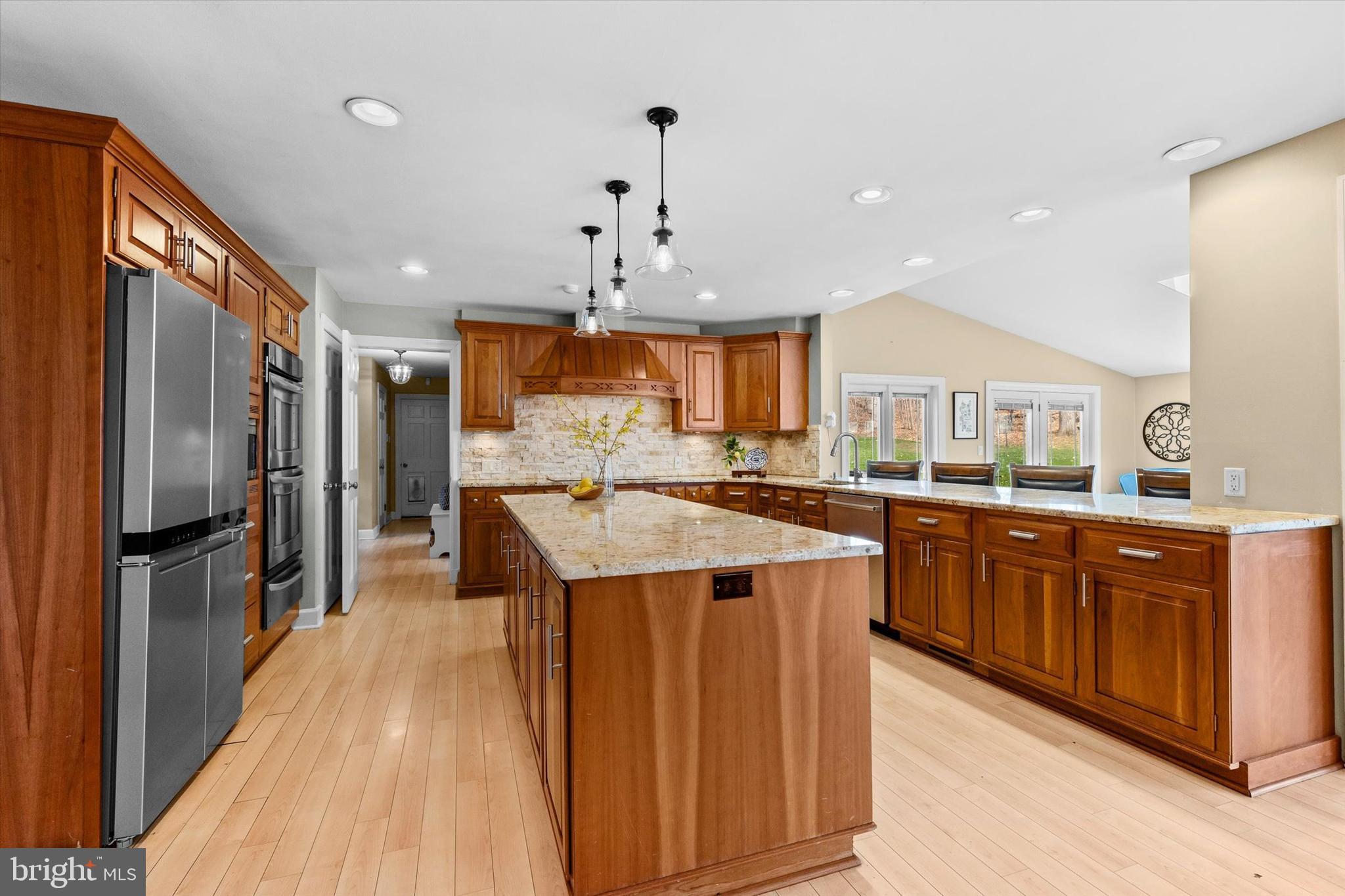 1979 Alcott Road York, PA 17402 - Photo 11 of 115 a kitchen with stainless steel appliances kitchen island granite countertop a refrigerator a sink dishwasher and a stove with wooden floor