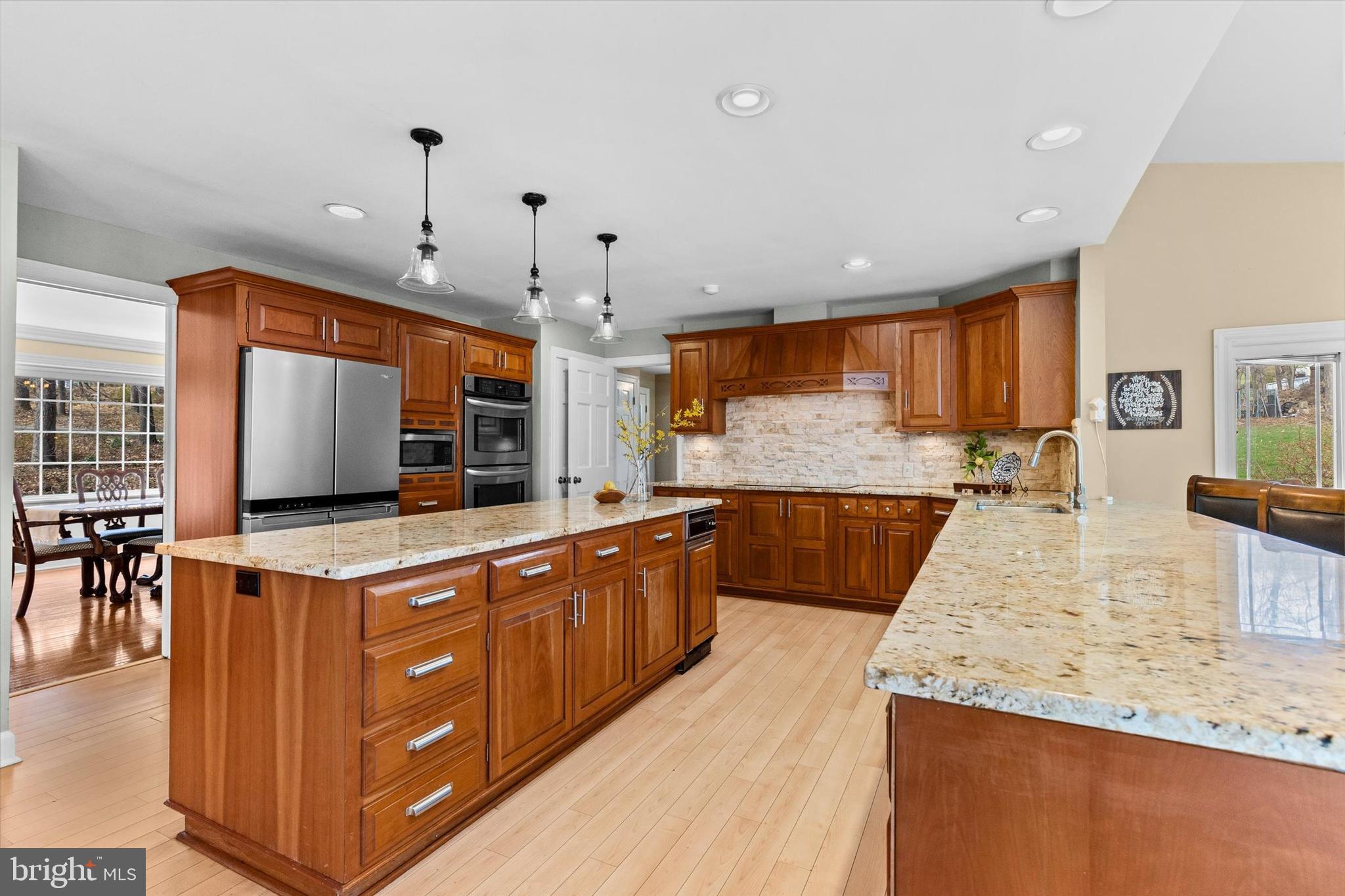 1979 Alcott Road York, PA 17402 - Photo 12 of 115 a large kitchen with kitchen island a large counter top space a sink stainless steel appliances and cabinets