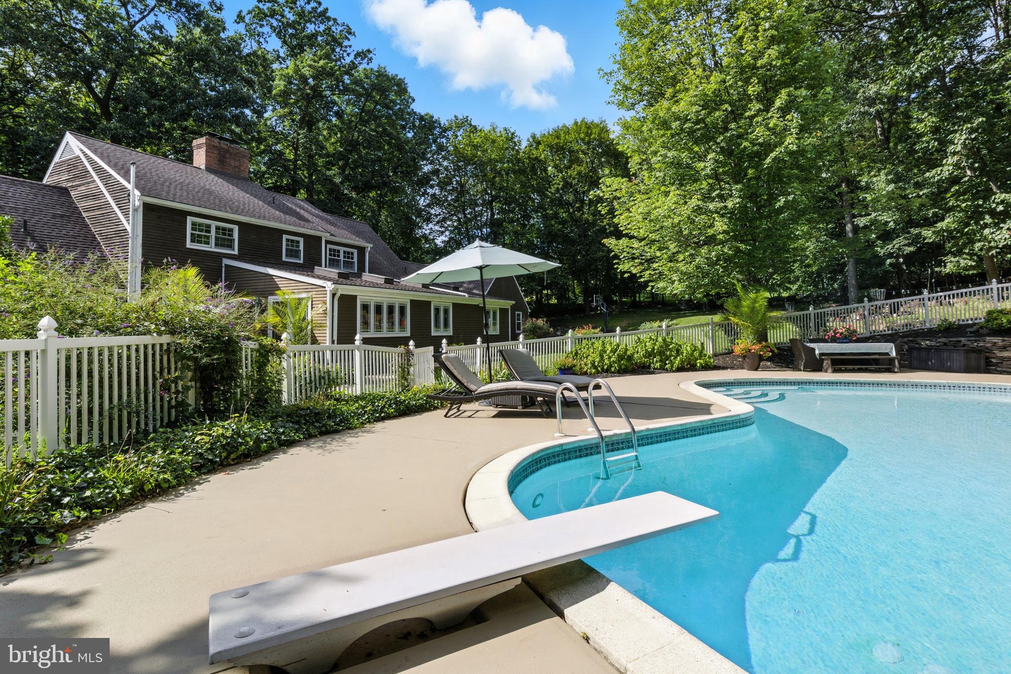 1979 Alcott Road York, PA 17402 - Photo 99 of 115 a view of a patio with chairs and a table and chairs under an umbrella