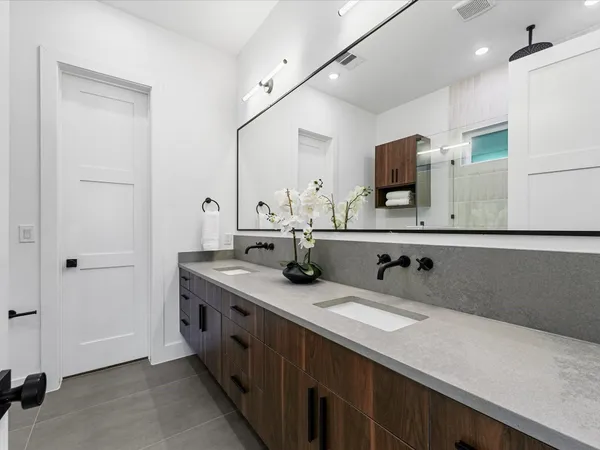 a bathroom with a toilet a sink and shower