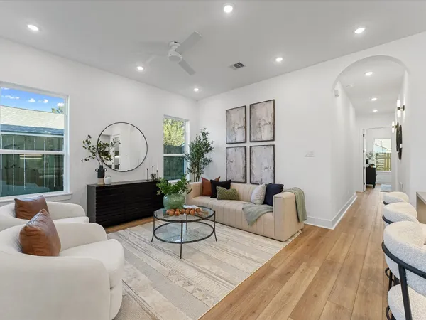 a living room with furniture a table and a large window