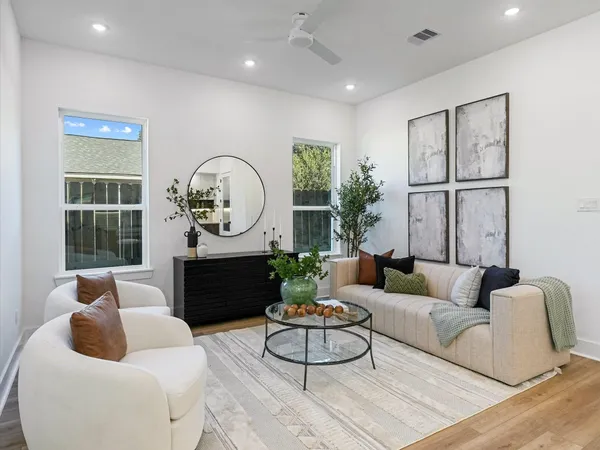 a living room with furniture a rug and a window