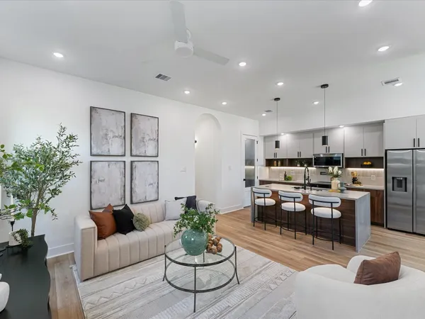 a dining room with furniture and a potted plant