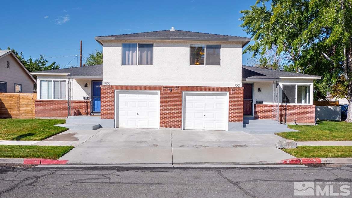 a front view of a house with a yard and garage