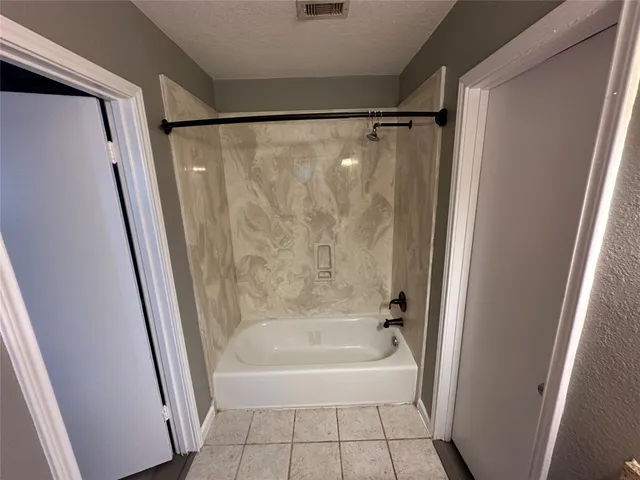 a bathroom with a shower and a bath tub