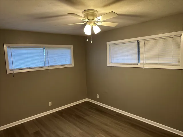 a view of room with window and wooden floor