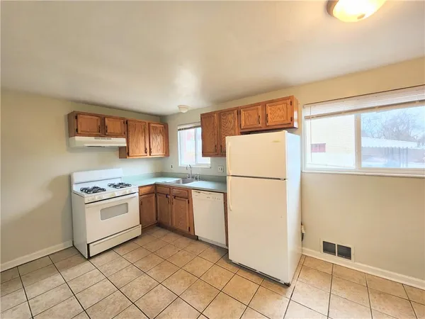 a kitchen with a refrigerator sink stove and cabinets
