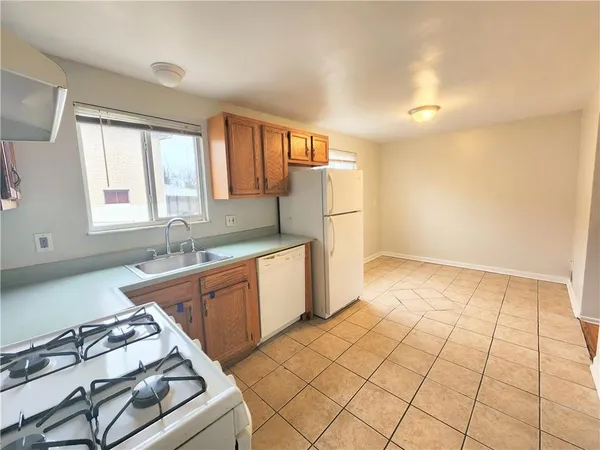 a kitchen with a sink a stove cabinets and counter space