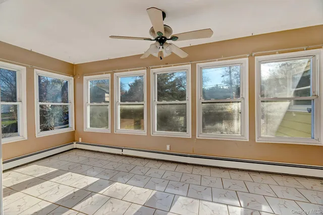 a view of a room with wooden floor and ceiling fan