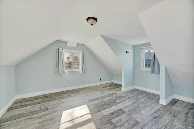 a view of a room with wooden floor and window