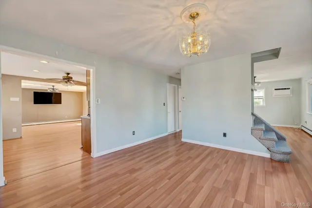 a view of a chandelier fan and wooden floor