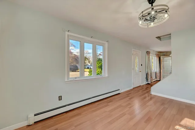 wooden floor in an empty room with a window
