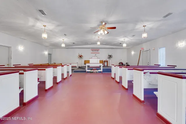 a large room with lots of furniture and a chandelier