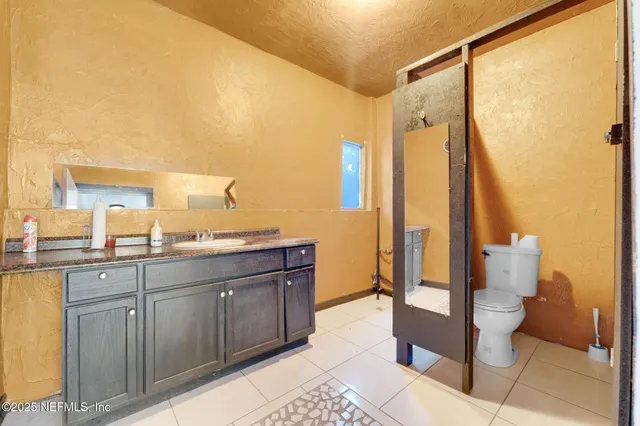 a spacious bathroom with a double vanity sink and a mirror