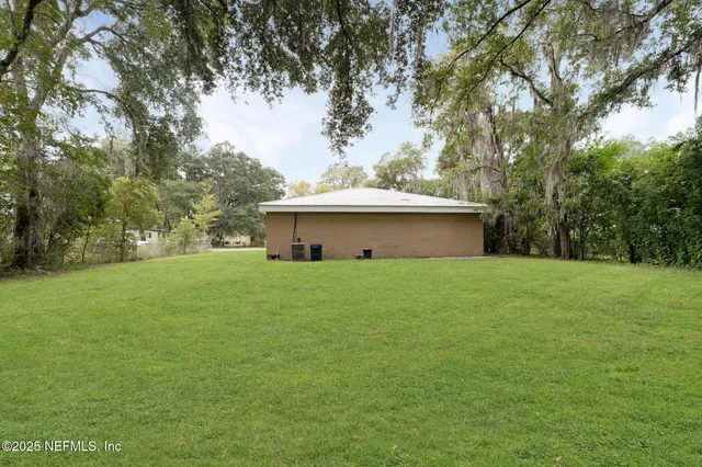 a front view of house with a garden