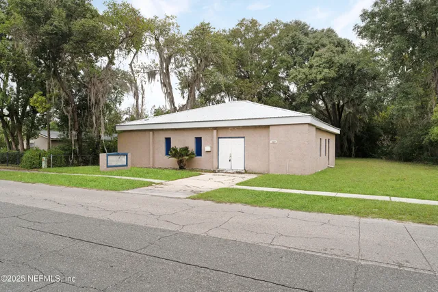 a house with a yard and a large trees