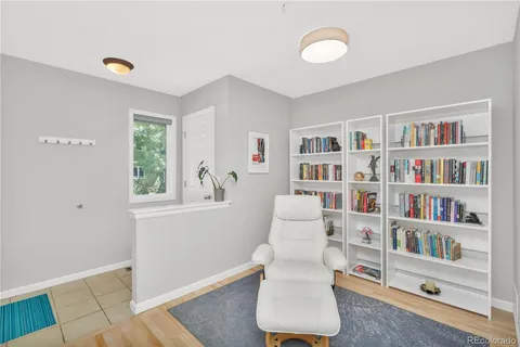 a living room with furniture and a book shelf