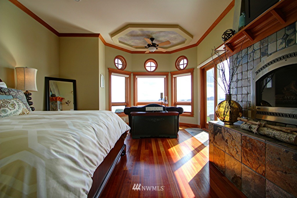 9690 Samish Island Road Bow, WA 98232 - Photo 11 of 25 a bed room with a bed and a large window