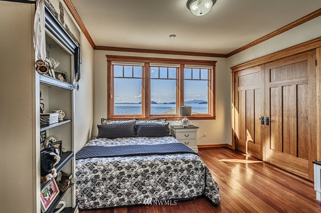 9690 Samish Island Road Bow, WA 98232 - Photo 13 of 25 a bedroom with a large bed and a window