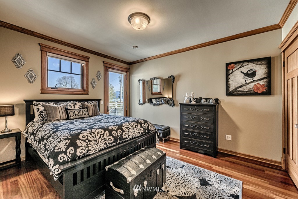 9690 Samish Island Road Bow, WA 98232 - Photo 15 of 25 a bedroom with a bed dresser and painting on the wall