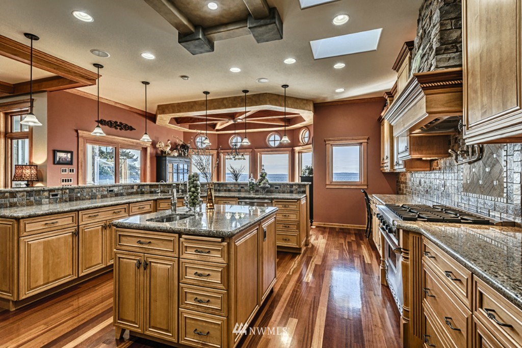 9690 Samish Island Road Bow, WA 98232 - Photo 8 of 25 a kitchen with stainless steel appliances granite countertop a stove and a sink