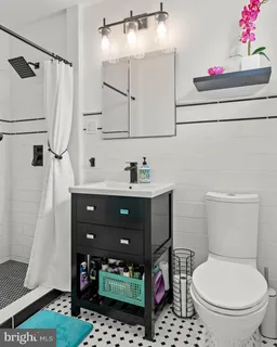 a bathroom with a toilet a sink and a shower