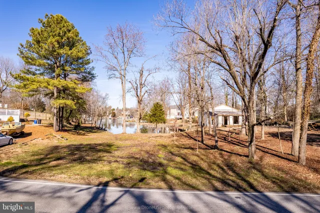 a view of yard covered with snow in front of house