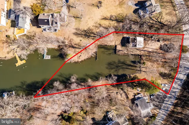 an aerial view of house with yard and mountain view in back