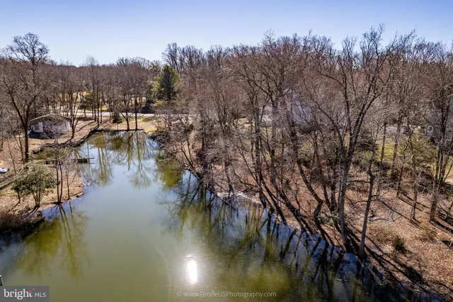 a view of residential house with outdoor space and lake view