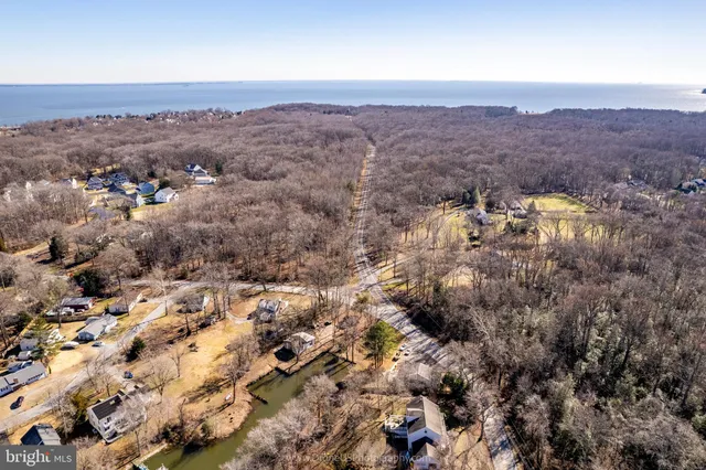 an aerial view of house with yard and mountain view in back