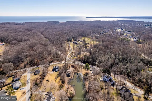 an aerial view of house with yard and mountain view in back