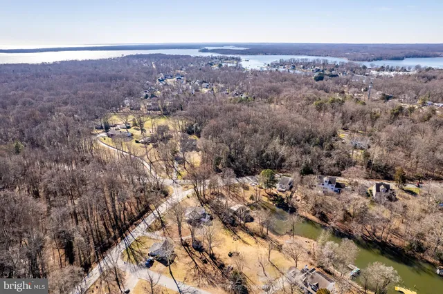 an aerial view of house with yard and mountain in the back
