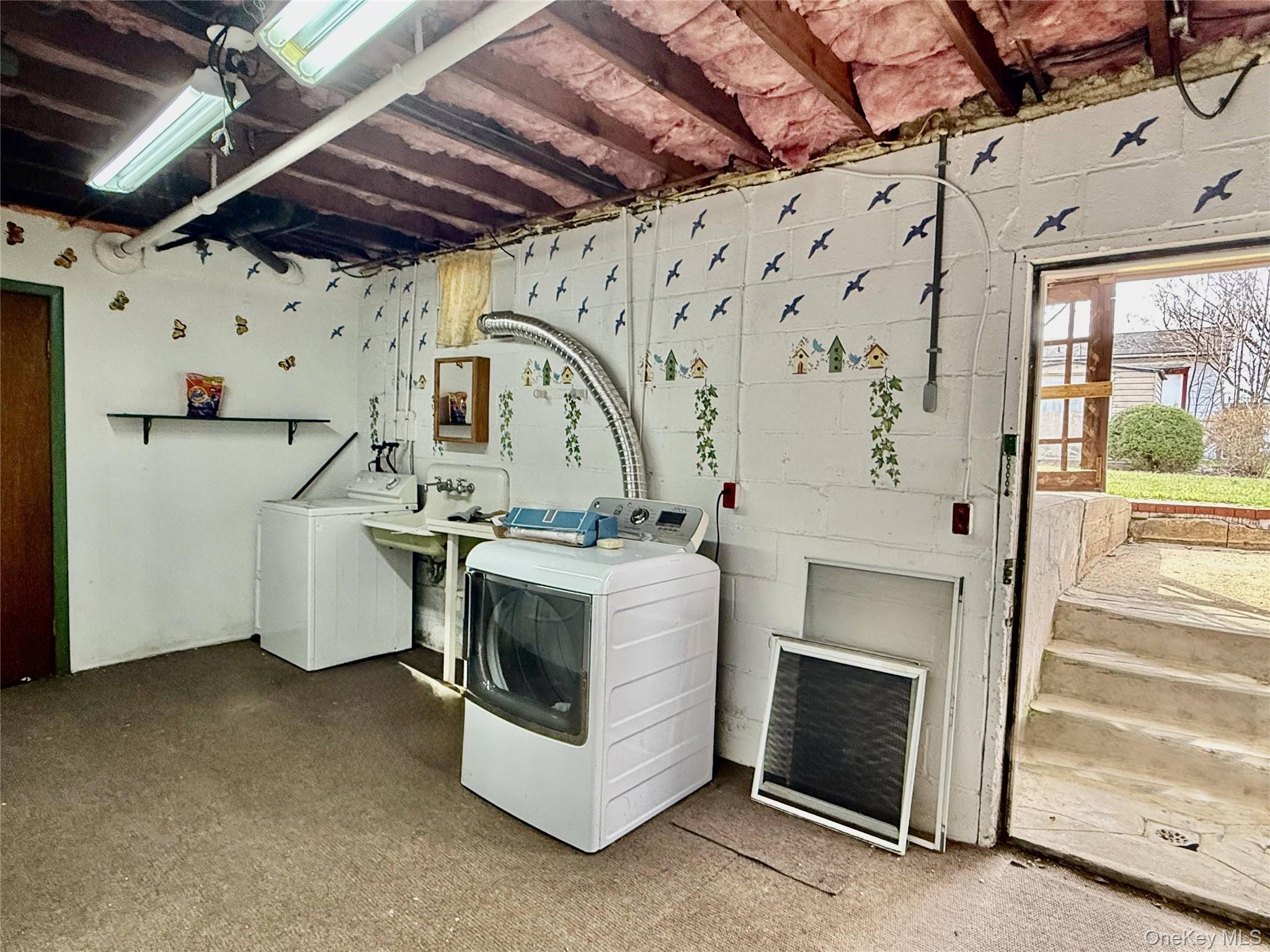 5 Lockwood Road Carmel, NY 10512 - Photo 24 of 35 Walk-Out Lower Level Laundry Room with plenty of storage and accesses to the garage and lovely fenced backyard with abundant lake views.