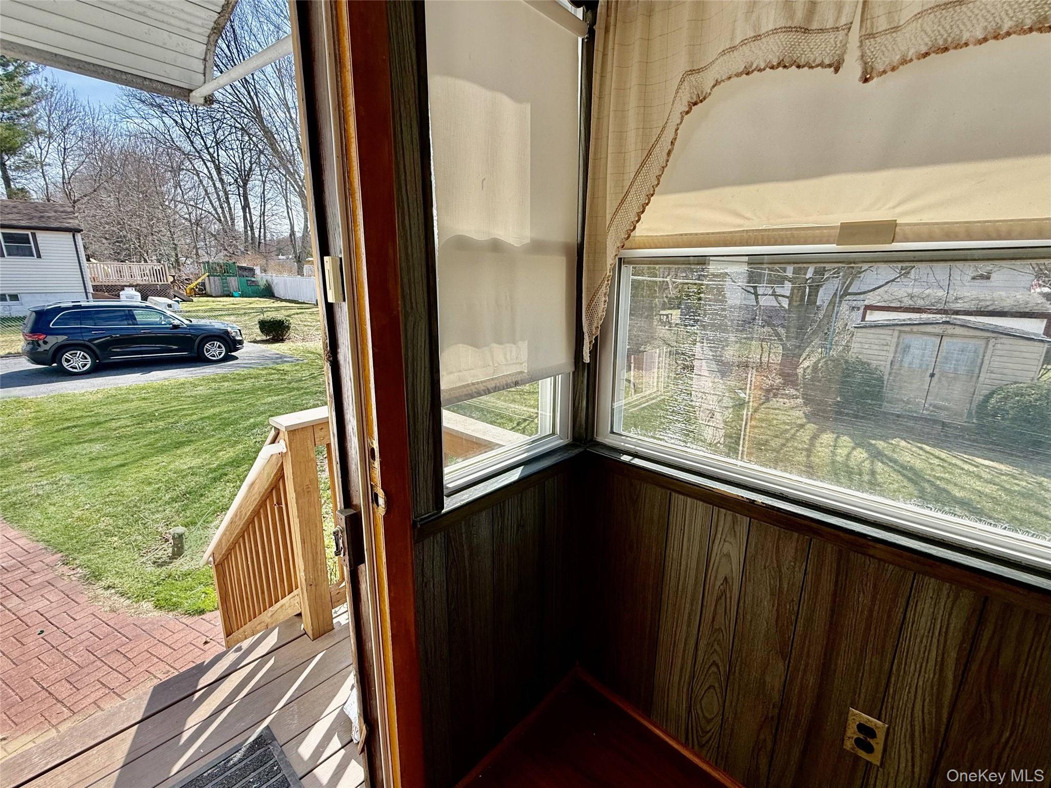 5 Lockwood Road Carmel, NY 10512 - Photo 26 of 35 Three Season Porch with direct backyard access, featuring a composite PVC decking staircase and classic brick walkway.