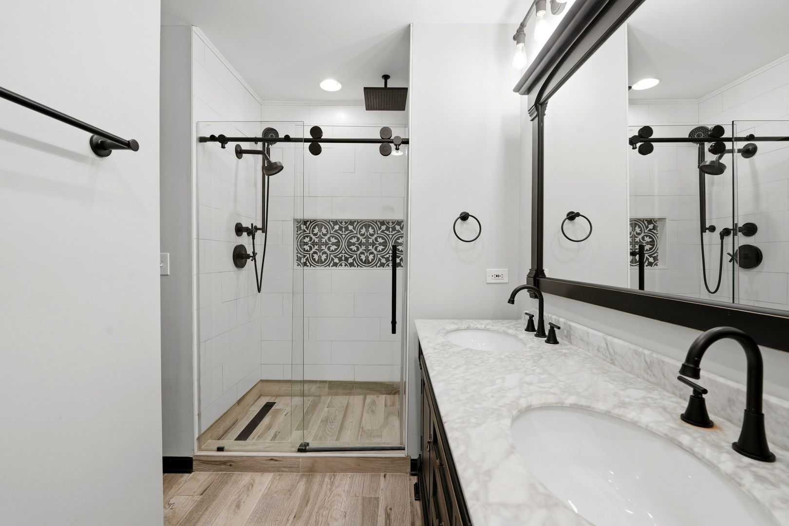619 North Racine Avenue, Unit 1 Chicago, IL 60642 - Photo 26 of 36 a bathroom with a granite countertop sink a mirror and shower