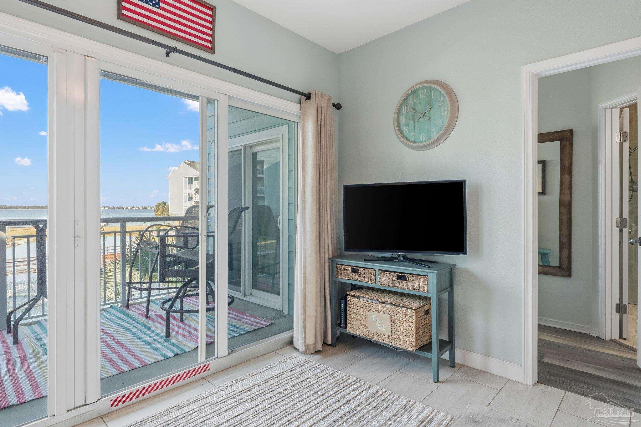 1150 Fort Pickens Road, Unit A3 Pensacola Beach, FL 32561 - Photo 12 of 36 a living room with furniture and a flat screen tv