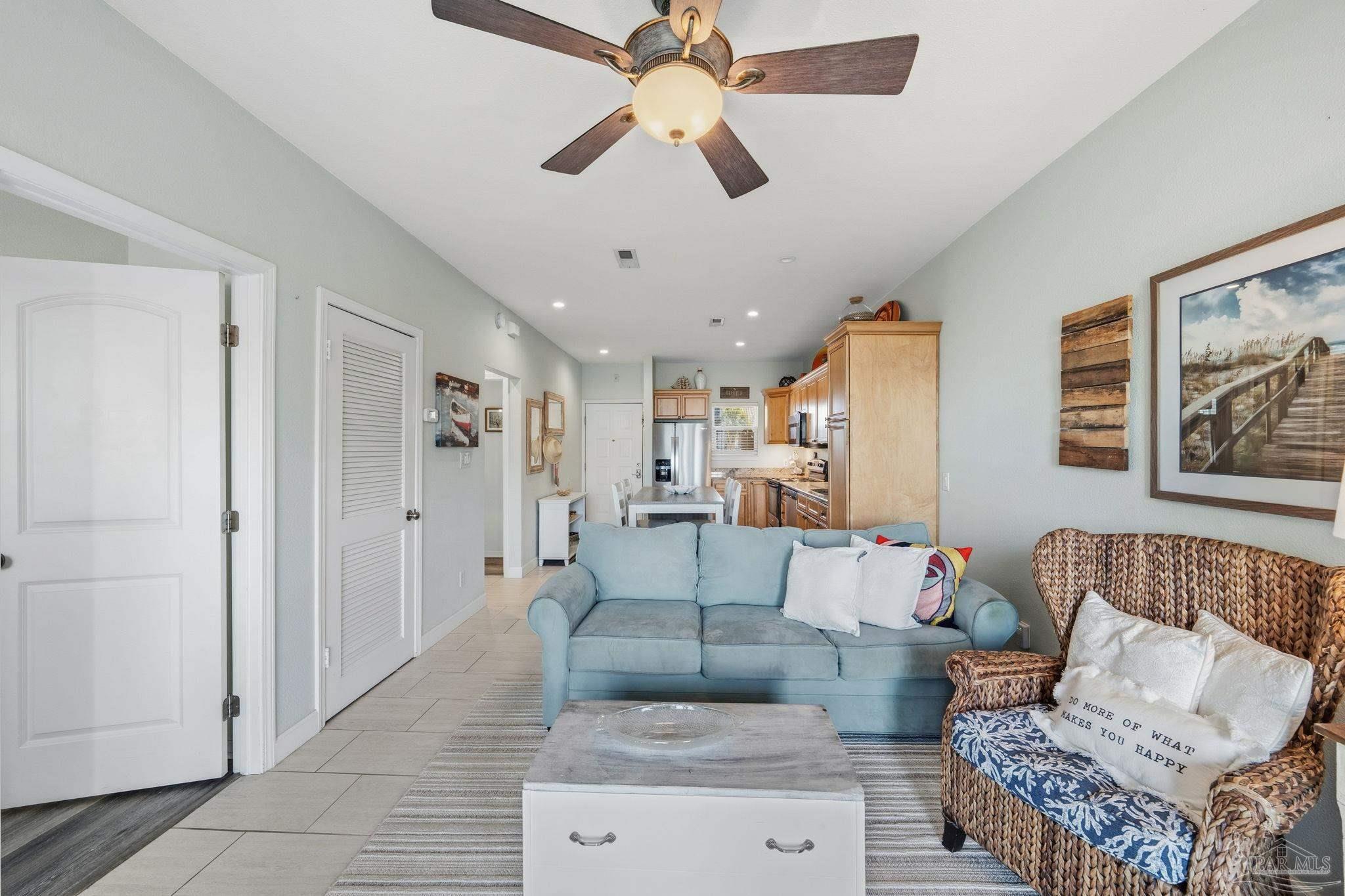 1150 Fort Pickens Road, Unit A3 Pensacola Beach, FL 32561 - Photo 13 of 36 a living room with furniture and a chandelier