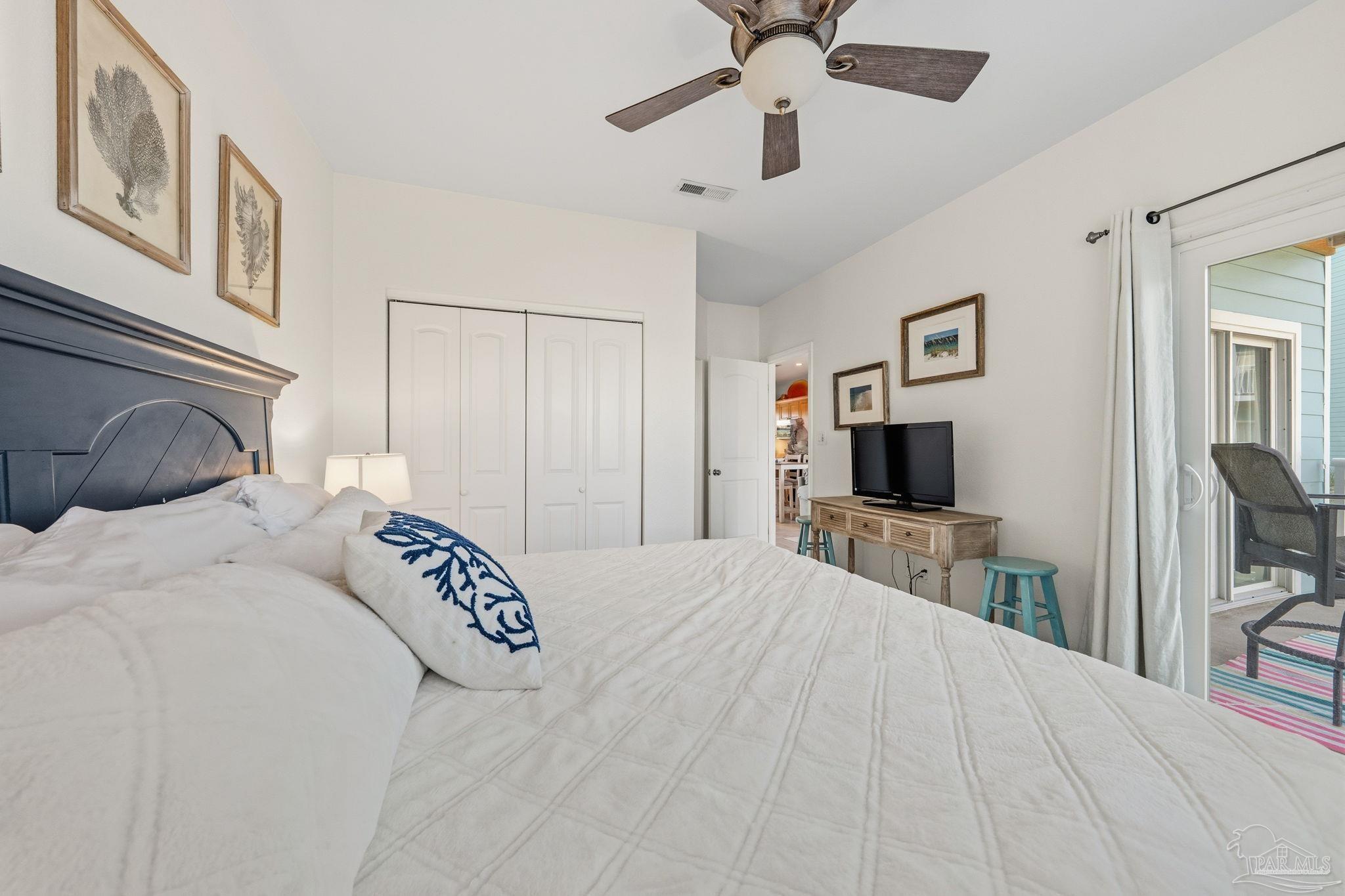1150 Fort Pickens Road, Unit A3 Pensacola Beach, FL 32561 - Photo 15 of 36 a bedroom with a bed and a flat tv screen on dresser