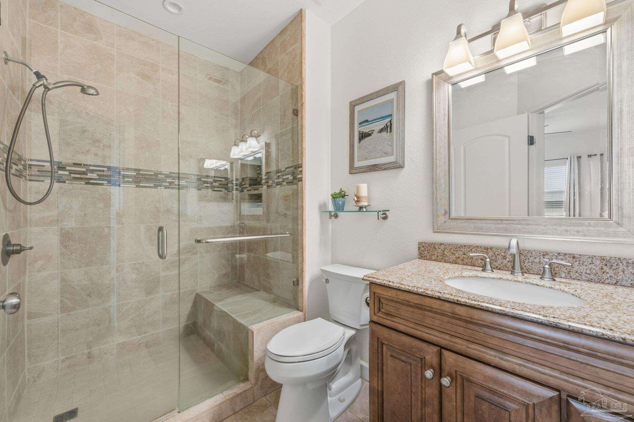 1150 Fort Pickens Road, Unit A3 Pensacola Beach, FL 32561 - Photo 17 of 36 a bathroom with a granite countertop sink toilet and shower