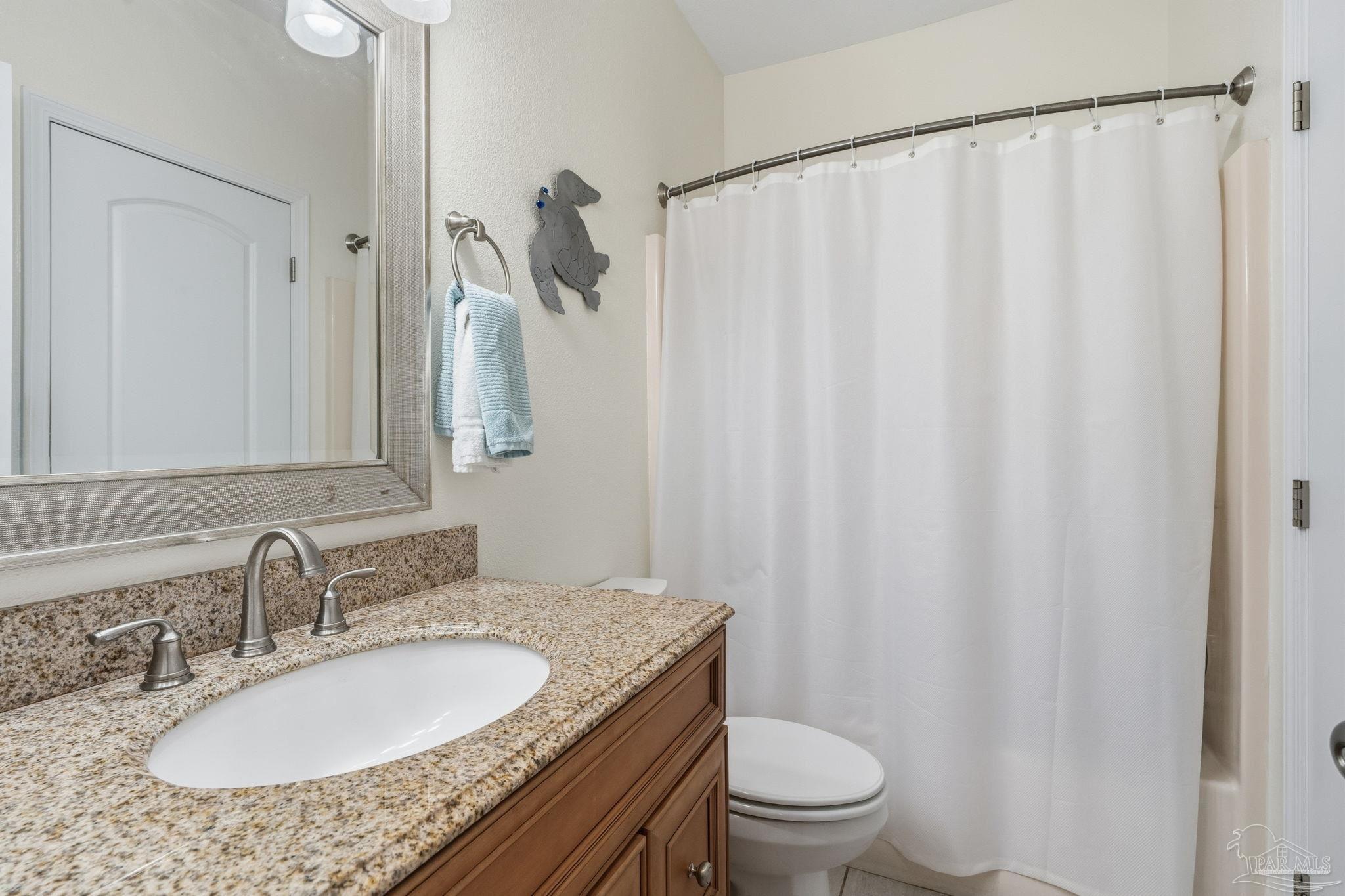1150 Fort Pickens Road, Unit A3 Pensacola Beach, FL 32561 - Photo 21 of 36 a bathroom with a granite countertop sink and a mirror