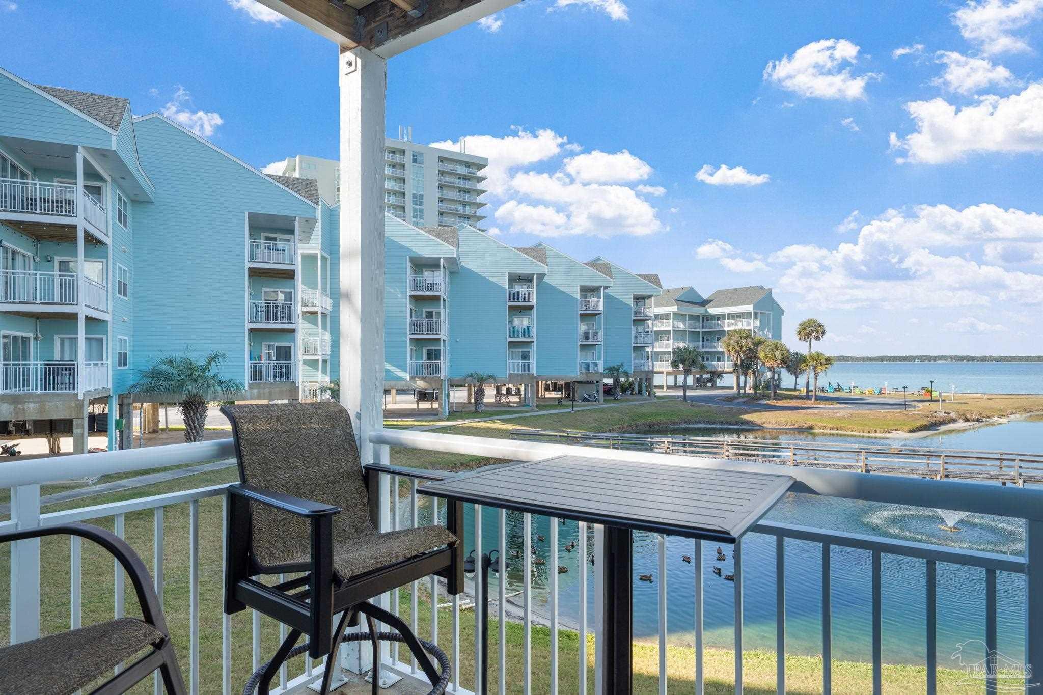 1150 Fort Pickens Road, Unit A3 Pensacola Beach, FL 32561 - Photo 23 of 36 a view of a chairs and table in the balcony