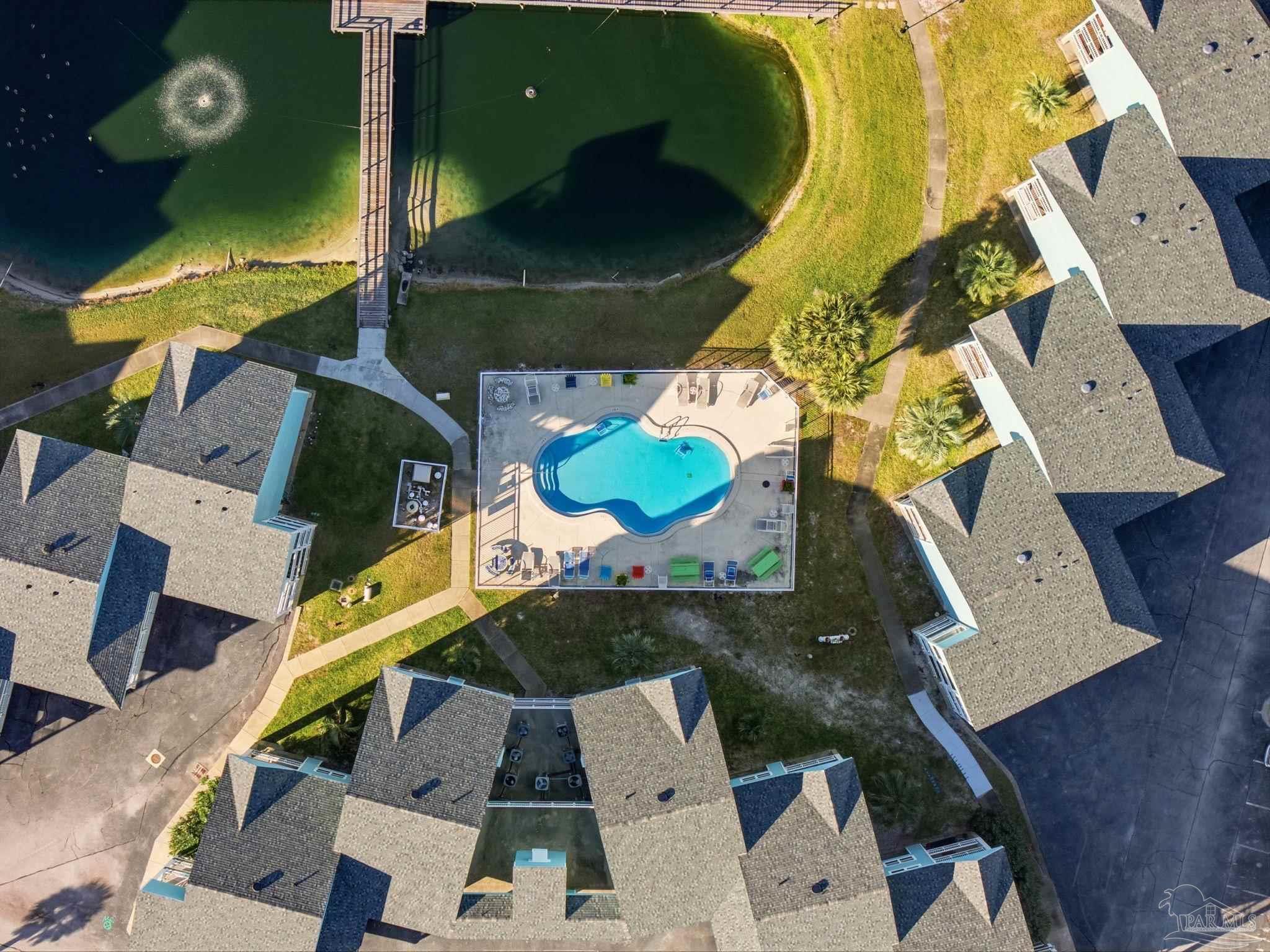 1150 Fort Pickens Road, Unit A3 Pensacola Beach, FL 32561 - Photo 35 of 36 an aerial view of a house with a yard and a large swimming pool