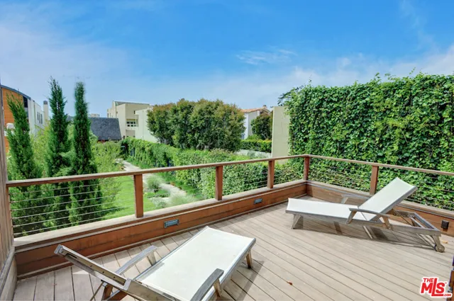 a view of a two chairs in the balcony